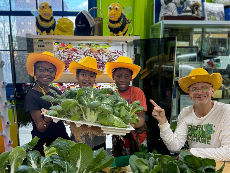 Stephen Ritz with Students holding harvested Bok Choy at C.S. 55